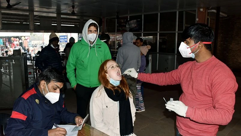 coronavirus, covid A healthcare worker collects a swab sample of a tourist for COVID-19 testing amid surge in coronavirus cases in some countries, at the eastern entrance of the Taj Mahal, in Agra.