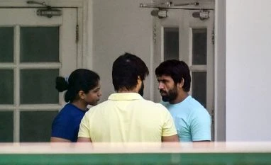 Wrestlers Sakshi Malik, Bajrang Punia and Satyawart Kadian arrive at the residence of Union Sports Minister Anurag Singh Thakur for talks, in New Delhi on Wednesday. Wrestlers Sakshi Malik, Bajrang Punia and Satyawart Kadian arrive at the residence of Union Sports Minister Anurag Singh Thakur for talks, in New Delhi on Wednesday.